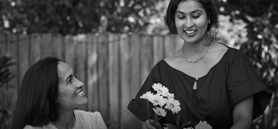 Woman holding flowers with friend