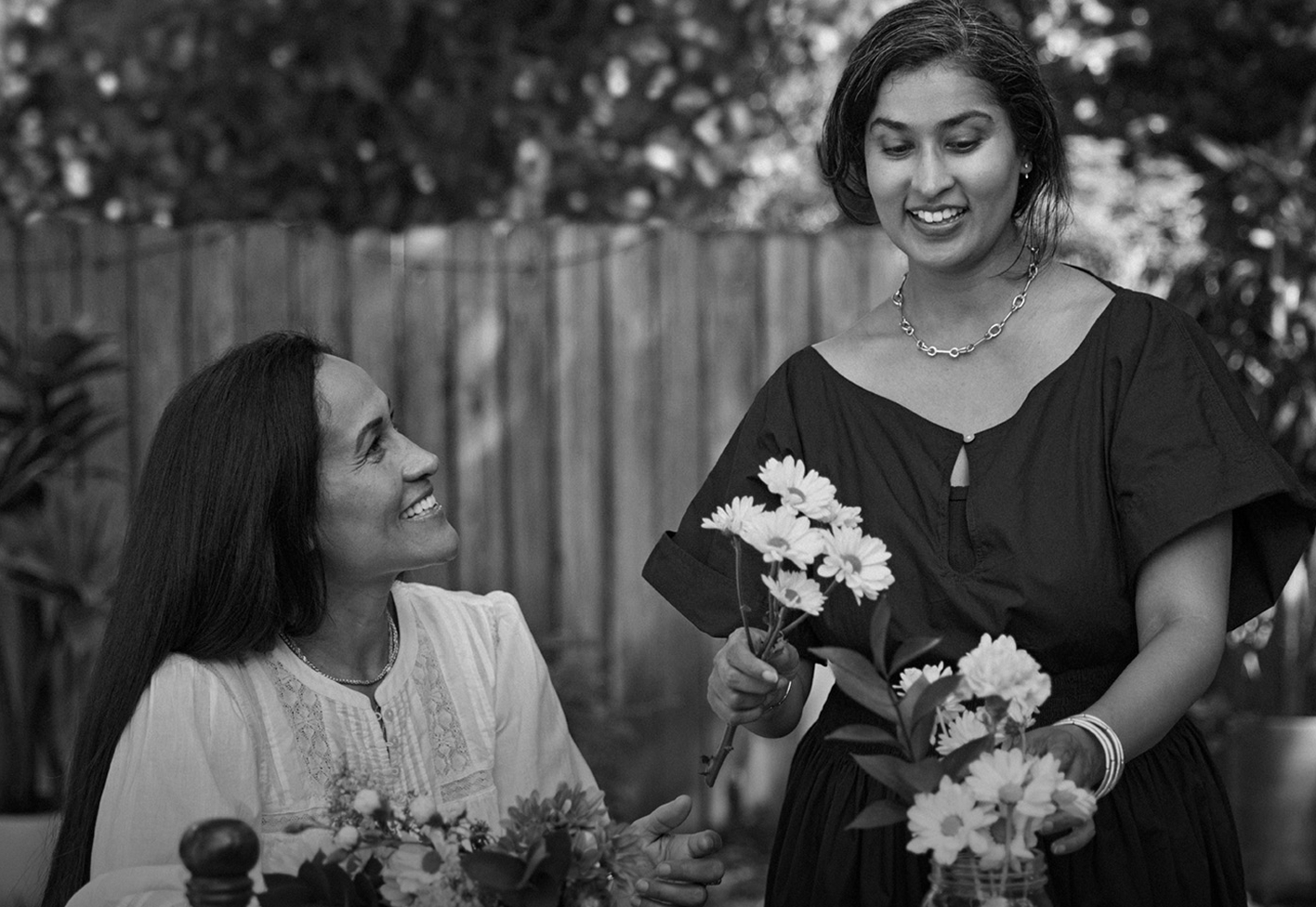 Woman holding flowers with friend