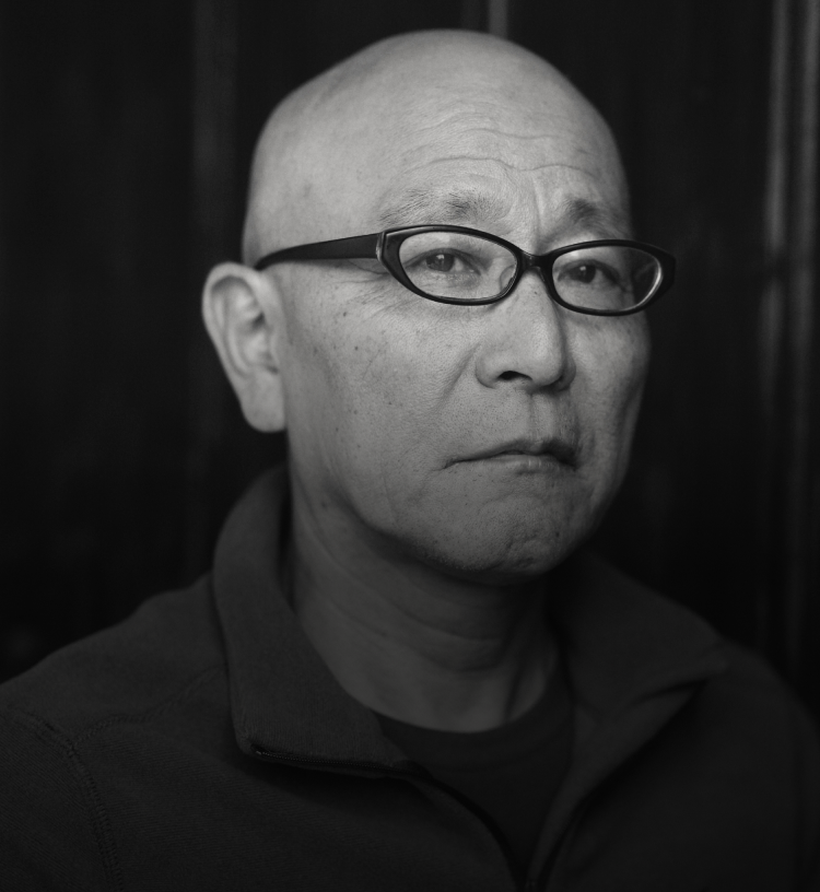 Somber man outside looking at camera