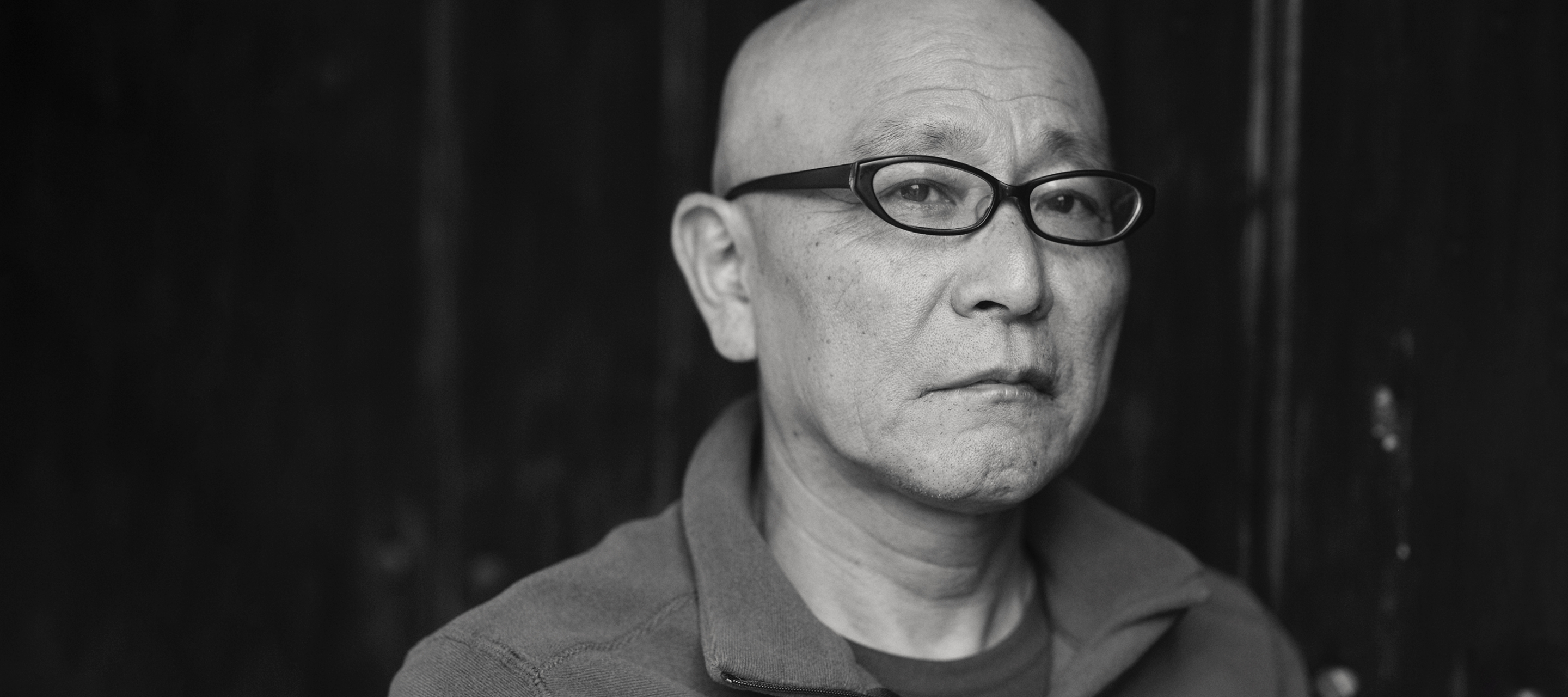 Somber man outside looking at camera