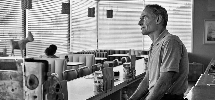 Man looking out window
