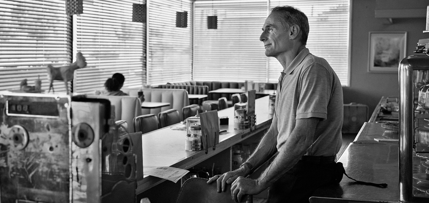 Man looking out window